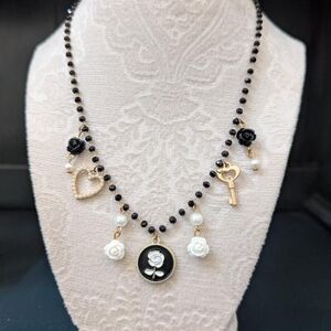 Elegant Black and Gold Necklace with Rose Charms